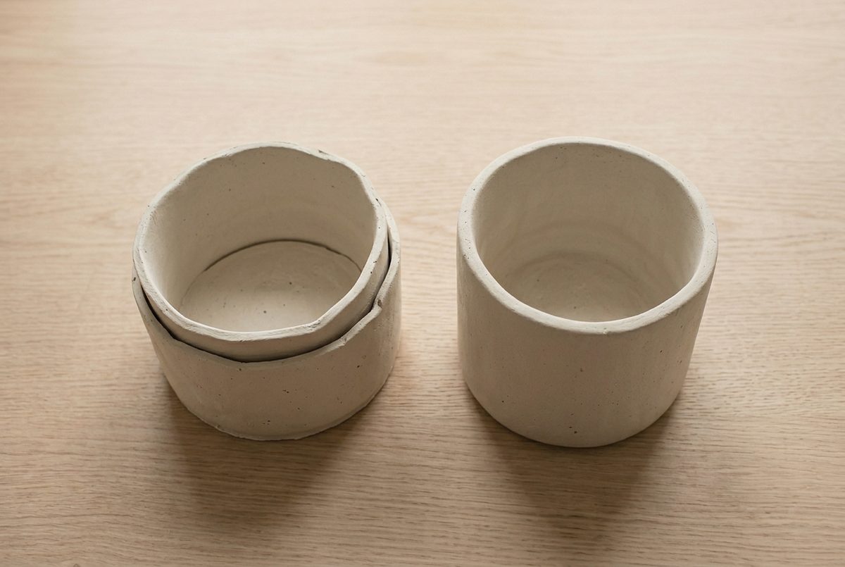 A pot whose wall has separated from the base beside a properly joined one