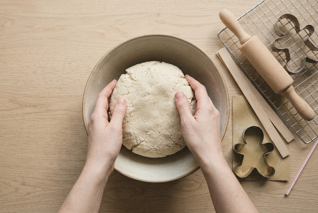 A stiff pale dough coming together in a mixing bowl